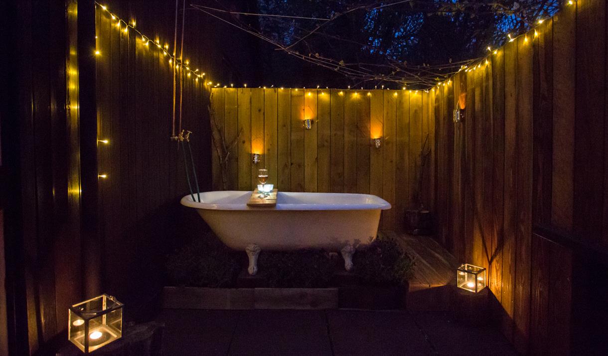 bathtub in the dark with fairy lights